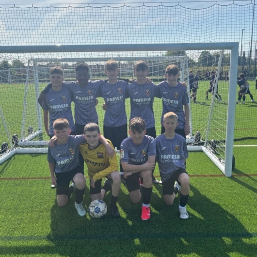 boys football team pose in the net